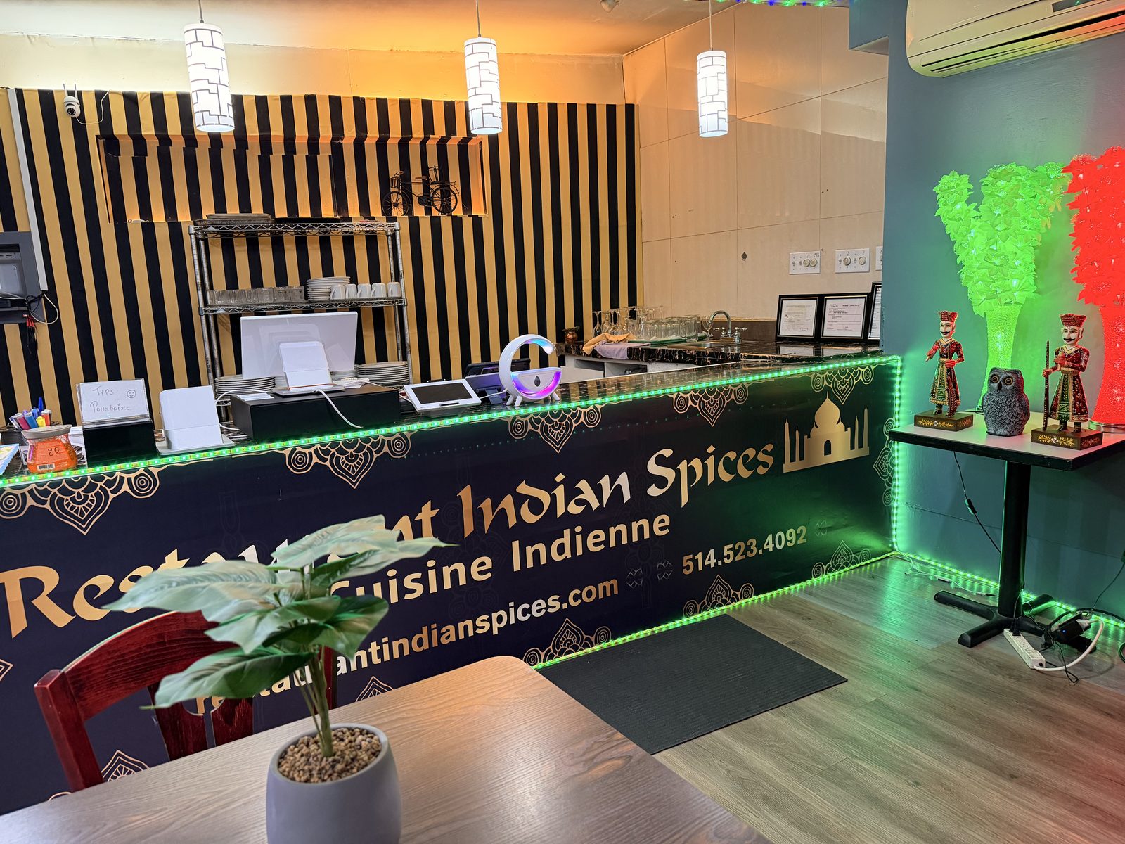 The front counter with the Restaurant Indian Spices sign and traditional Rajasthani decor